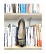 black and gold loafers with books 
